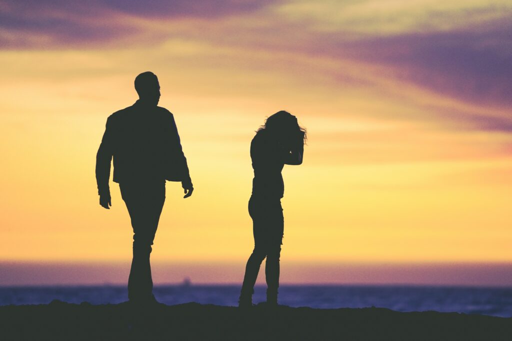 couple showing complex emotions during sunset