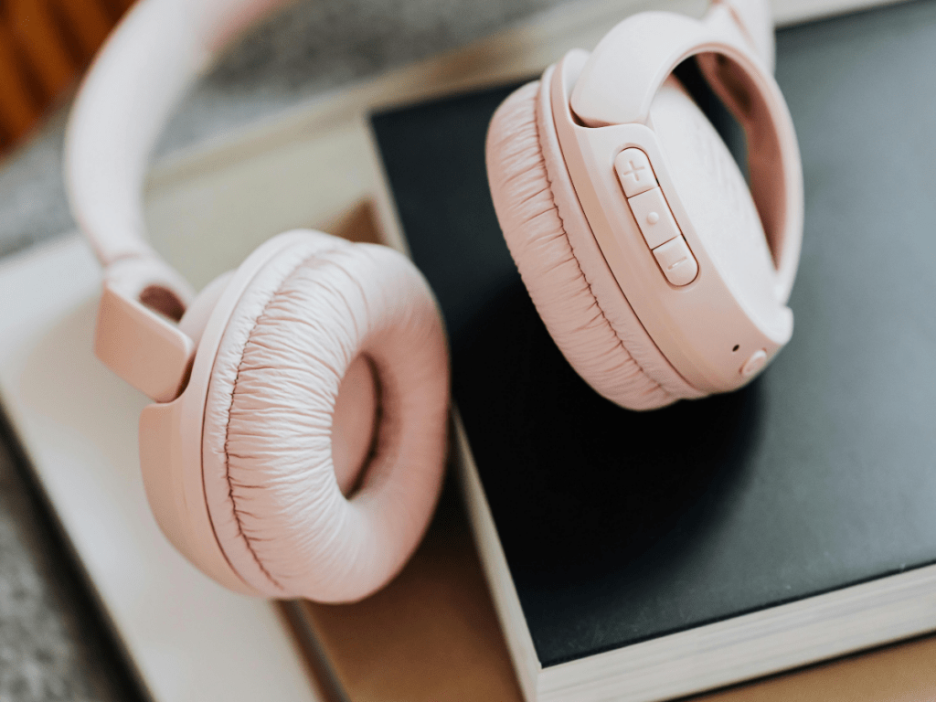 Over-ear headphones resting on a book, representing a private setup for a teletherapy session