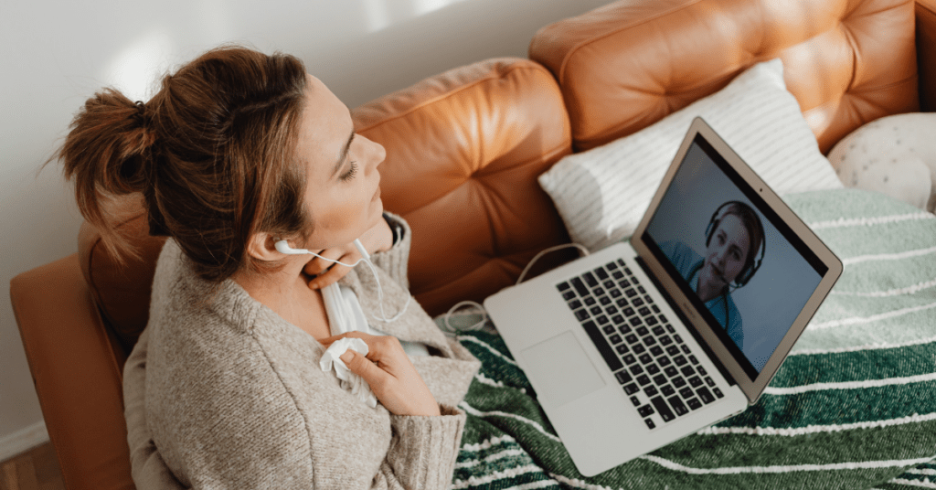 woman laying on couch during a video call
