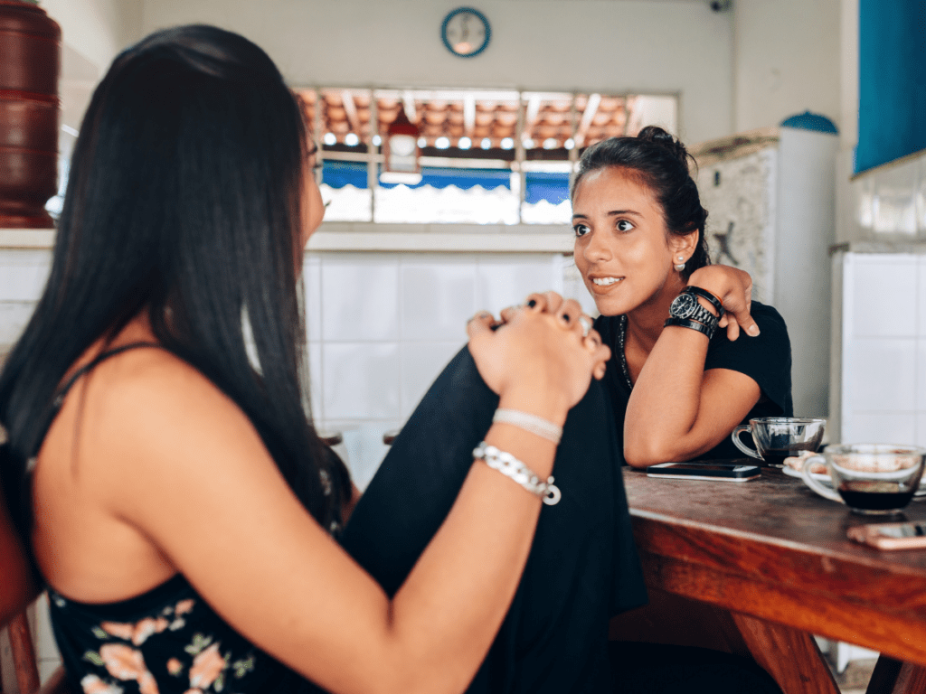 two peers talking during breakfast at a coffee shop